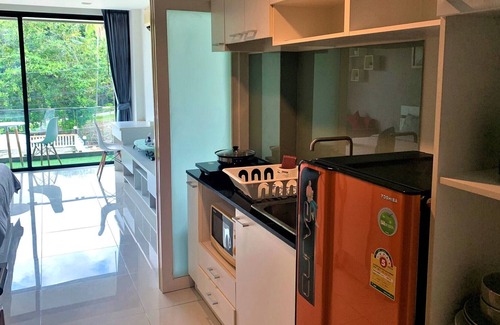 Wichit Apartment | Cozy Pool view Studio Suite | Kitchen | Balcony