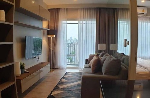 Nonthaburi Apartment | Modern 1-bedroom condo for up to 2 guests at Amber by Ester Star. Includes a separate bedroom, living area, kitchen, dining space, washing machine, balcony, city view and access to pool, gym, co-working space and shared building amenities.