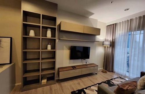 Nonthaburi Apartment | Modern 1-bedroom condo for up to 2 guests at Amber by Ester Star. Includes a separate bedroom, living area, kitchen, dining space, washing machine, balcony, city view and access to pool, gym, co-working space and shared building amenities.